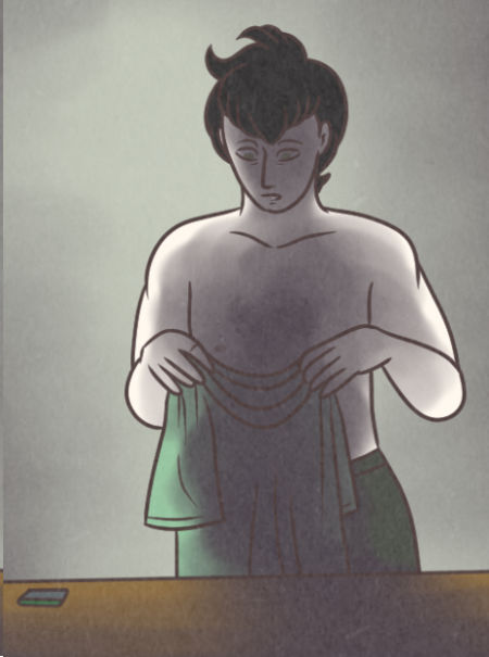 Tab stands in his darkened studio, holding up a green shirt while his phone sits on the table.