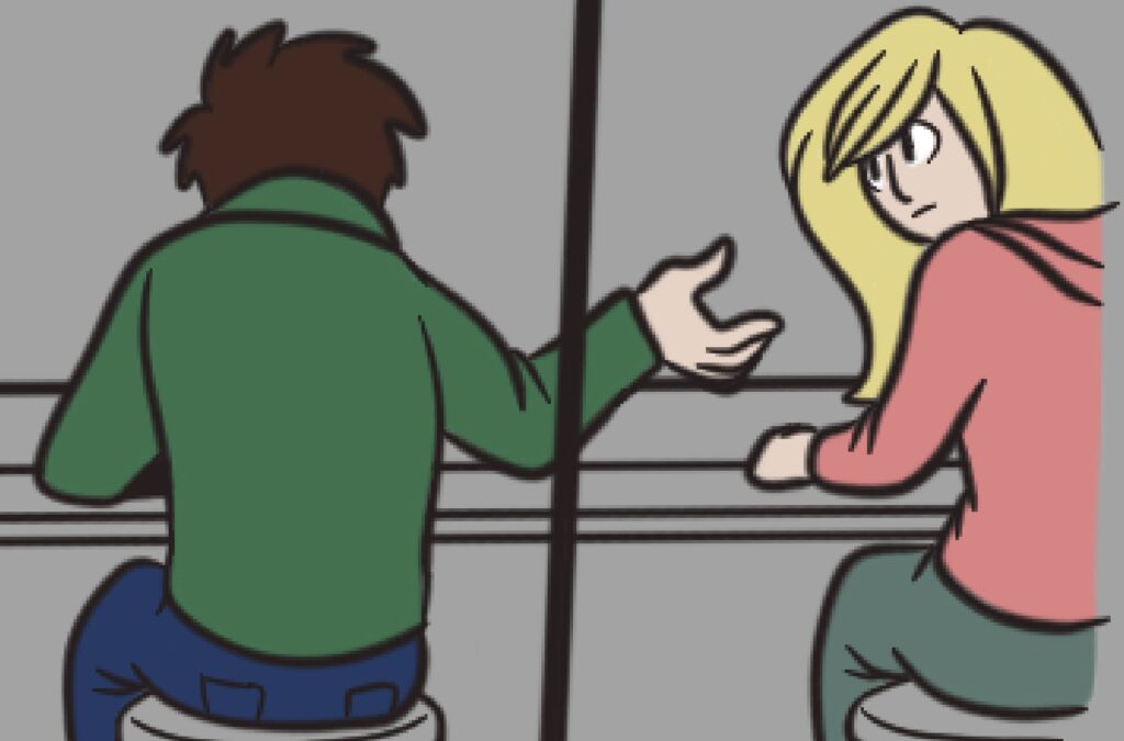 A man and a woman sit on stools at a bench with their backs to the viewer. The man wears a green hoodie, the woman wears a pink hoodie. The woman has her face toward the man, giving the viewer a glimpse of her blonde hair.