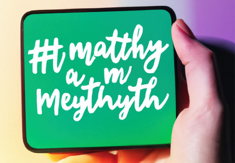 An AI-generated image of a hand holding a small tablet that reads #matthy a m meythyth. It's supposed to read, 'My mental health is doing much better.'