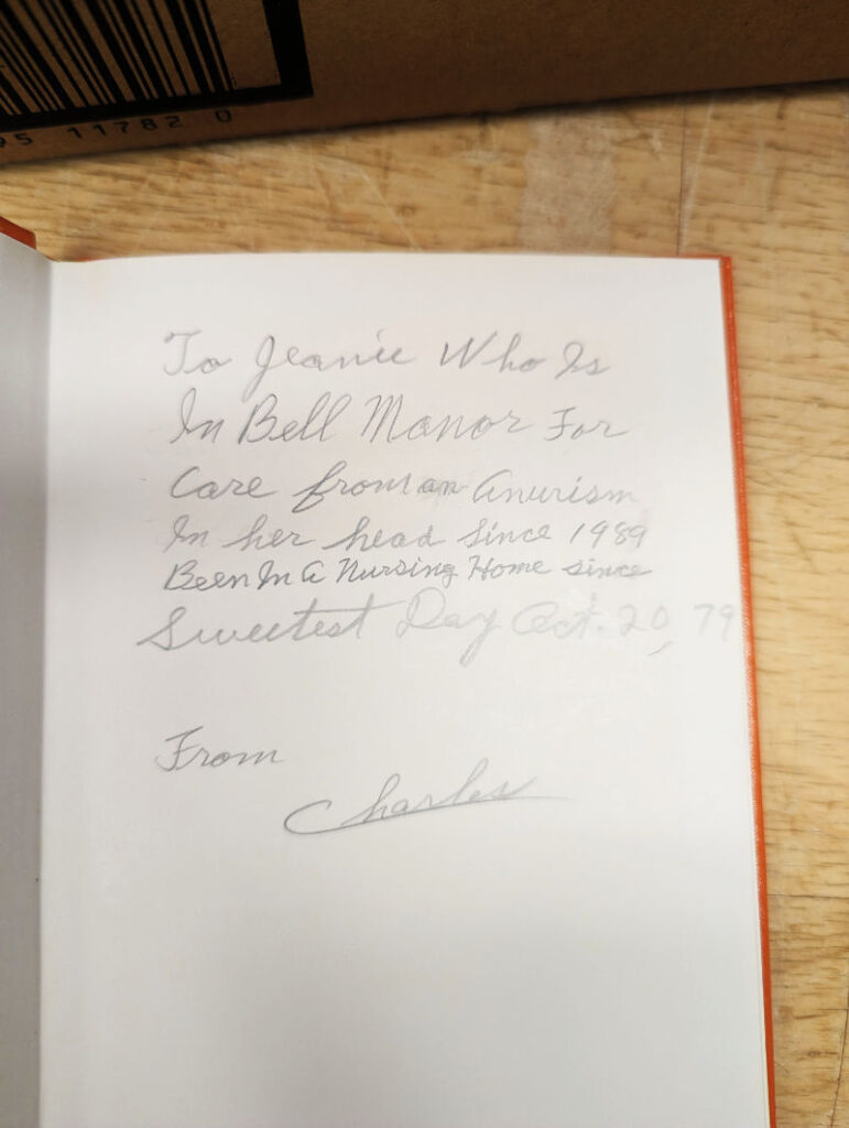 A person has written a dedication to his partner inside the book.