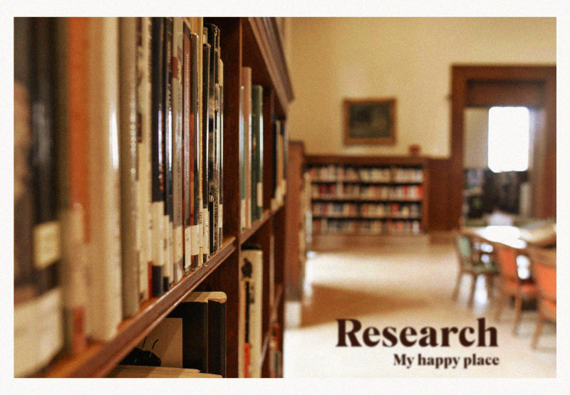 A close up view of a library bookcase to the viewer's left, leading the eye to a blurry view of shelves and desks in the distance. The header text reads, 'Research, my happy place.'